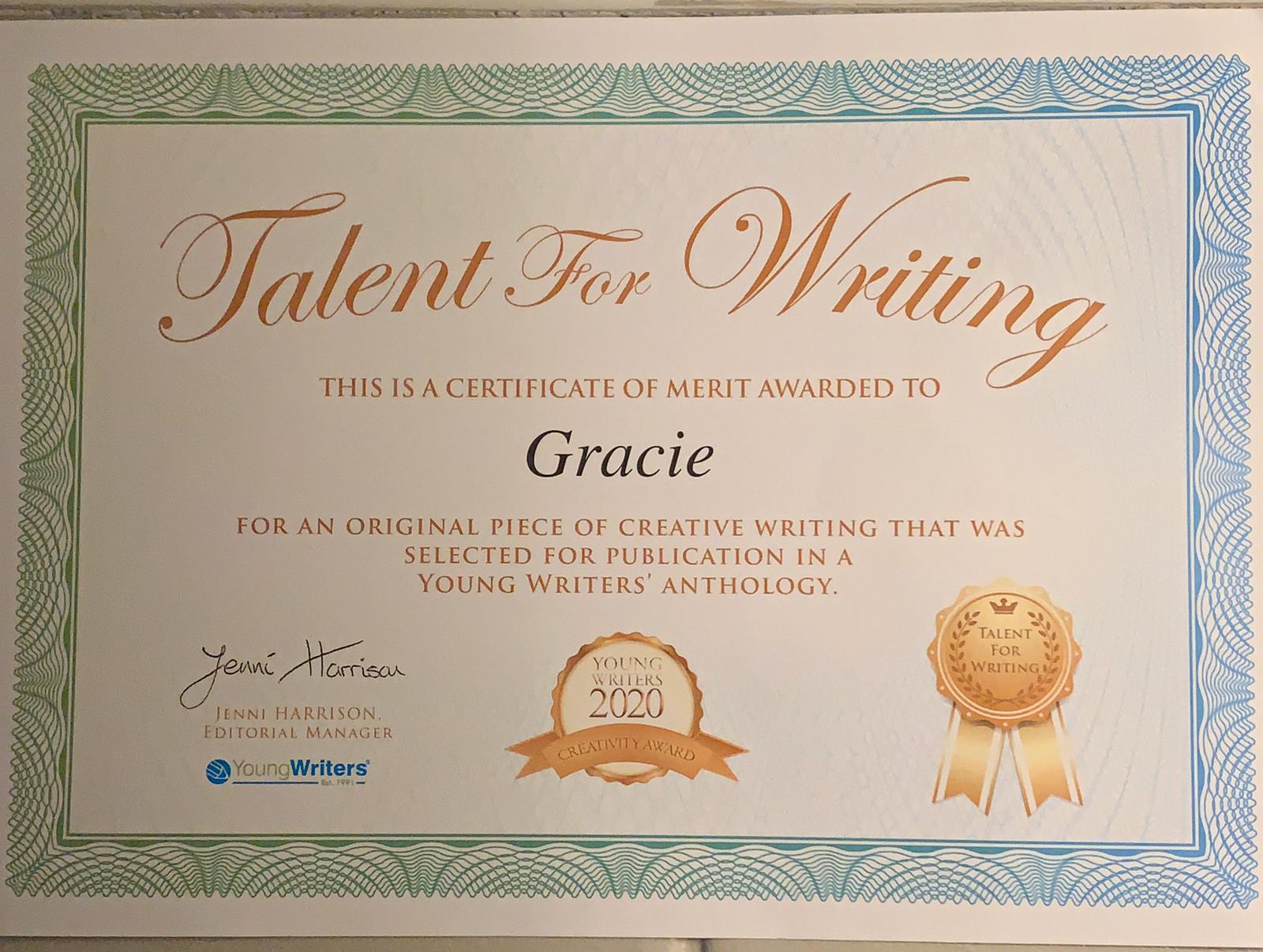 Grace holding her certificate saying Young Writers 2020 Creativity Award 