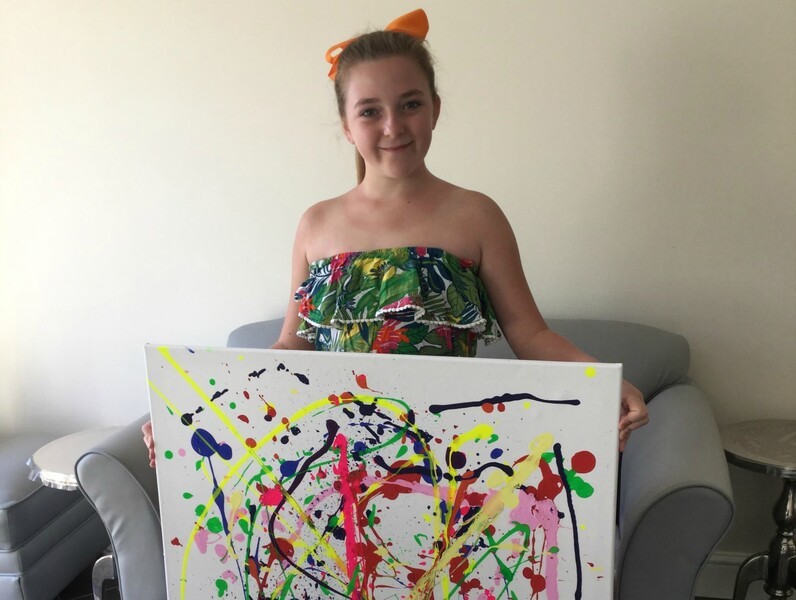 Young girl Samantha Brian with a painting she completed for her Arts Award 