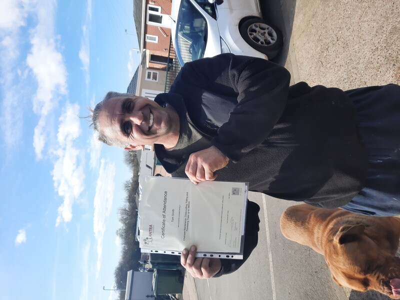 Man holding up his certificate