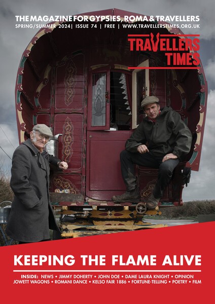 two men posing in front of a traditional red Romany bow top wagon