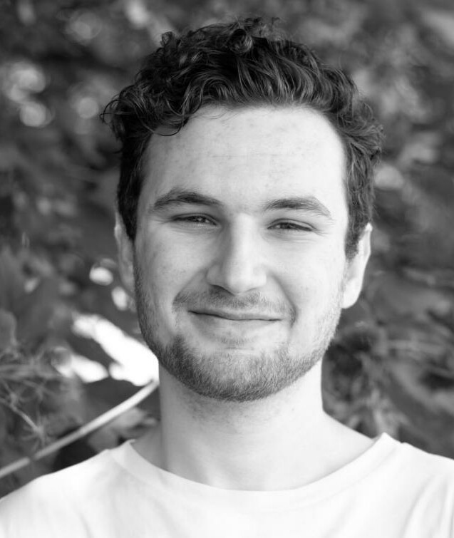 White man with short hair smiling at camera