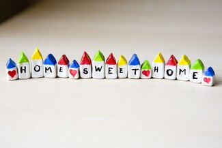 Home sweet home (each letter written on coloured rocks)