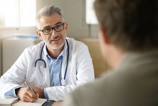 Male doctor talking to male patient