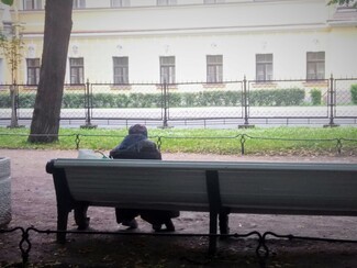 Nastiya, an old Romani woman, sitting on a bench in Gorky Park. She said she saw police beating homeless people and forcing them on to buses near Kazansky Train Station in Moscow.