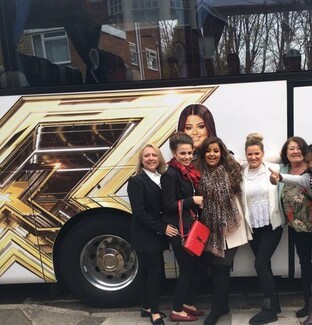 Scarlett Lee with with her proud family standing outside her tour bus 