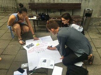 3 Girls writing on paper in workshop 