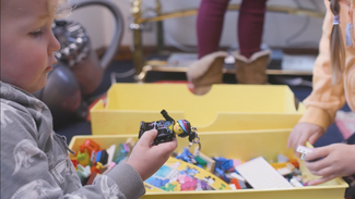 Child playing with lego 