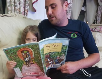 Young Dad reading with daughter 