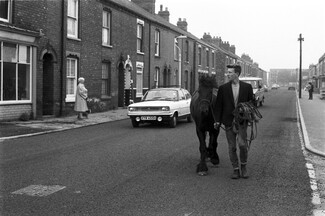 George Norris leads his horse Sally along Woodcock Street in Hull, 1983 © Russell Boyce