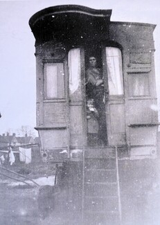 A woman looks out of her vardo (Gypsy horse-drawn wagon) on the Black Patch in Birmingham. Photograph courtesy of Harry Smith