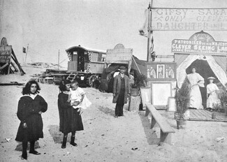 The fortune-telling booth of Jennie Boswell, the second wife of Tobias Boswell. Tobias is another son of "Gipsy Sarah" and Edward Boswell. Tobias stands to the left of the booth. 