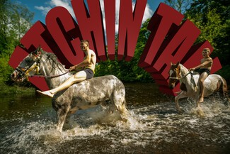 Two young adults riding horses through a river. Words behind in red says, "Atchin Tan".