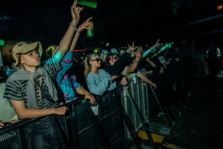 night concert and young crowd dancing